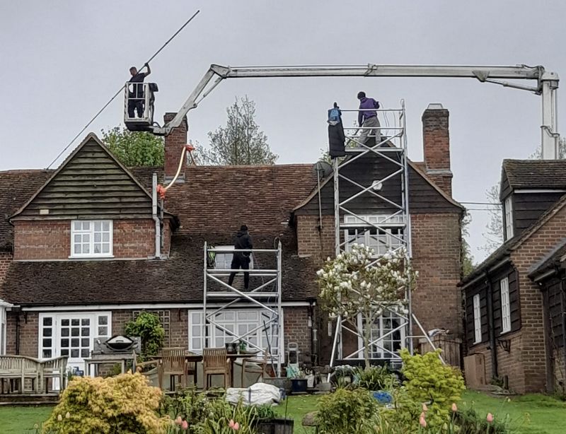 The Roof Moss Cleaners using cherry picker and scaffolding to clean roof safely and professionally in Bracknell, Berkshire